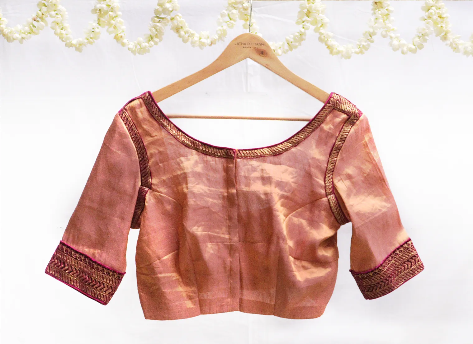 Dark pink velvet potli with gold jari embroidery