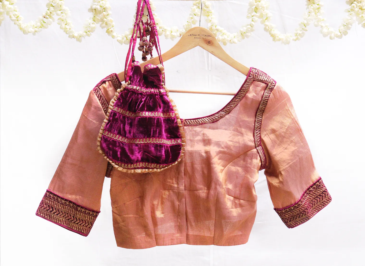 Dark pink velvet potli with gold jari embroidery